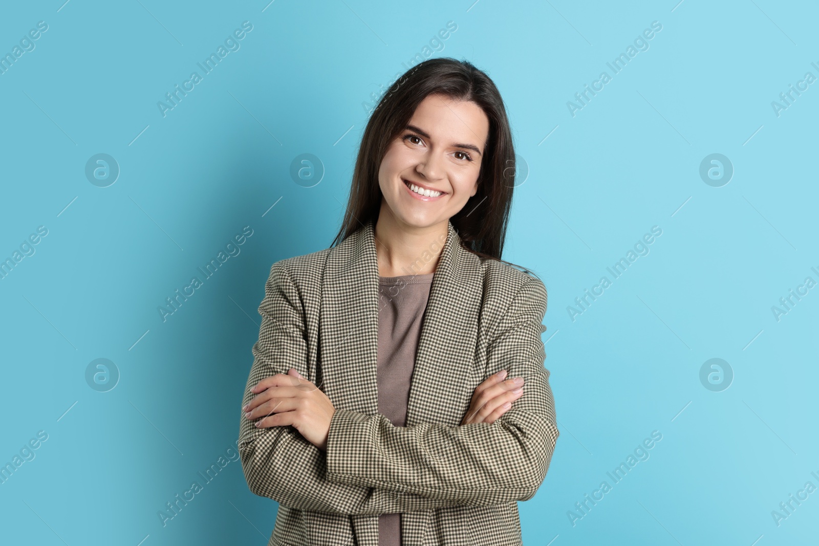 Photo of Portrait of banker with crossed arms on light blue background