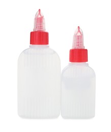 Photo of Bottles of glue with caps isolated on white