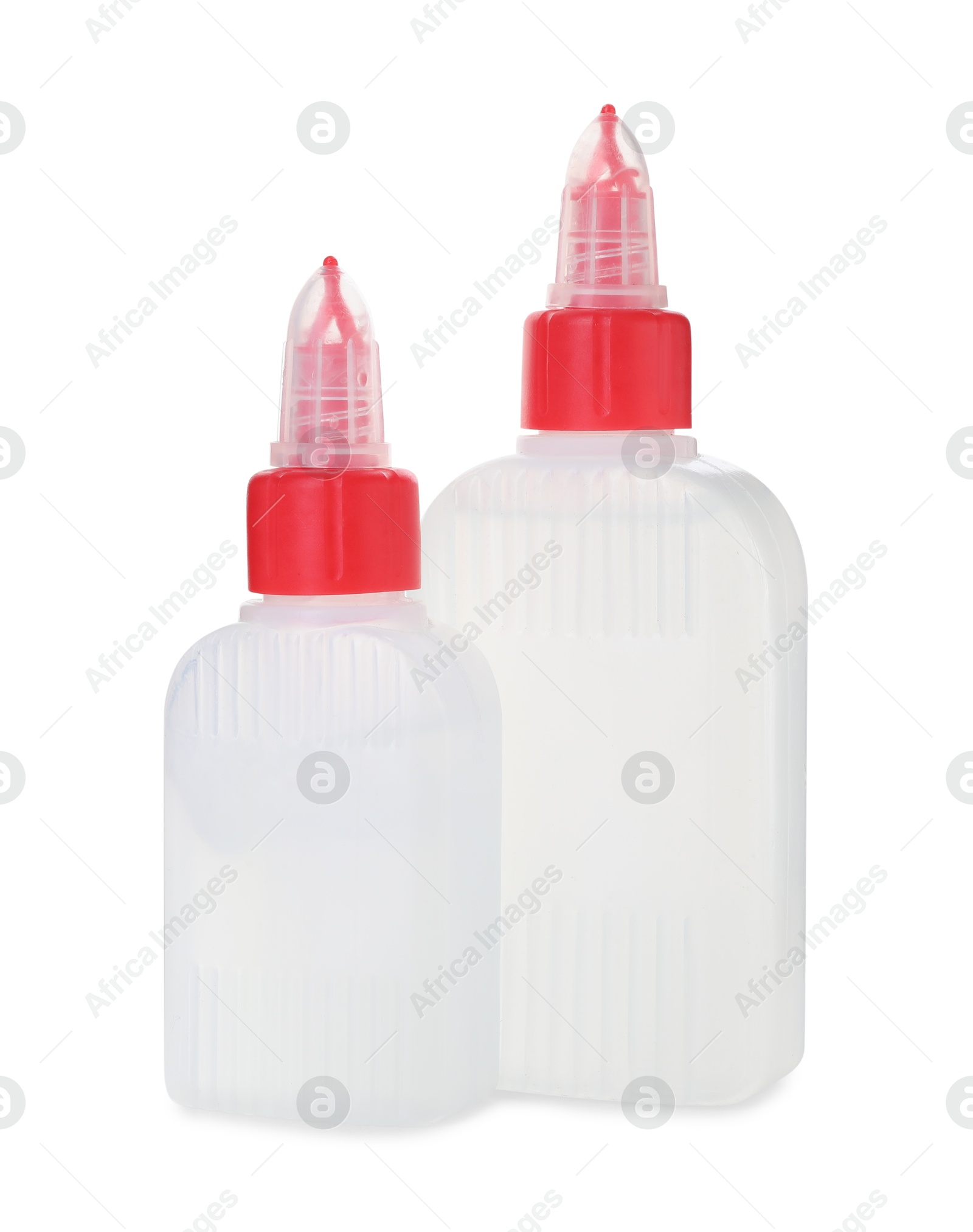 Photo of Bottles of glue with caps isolated on white