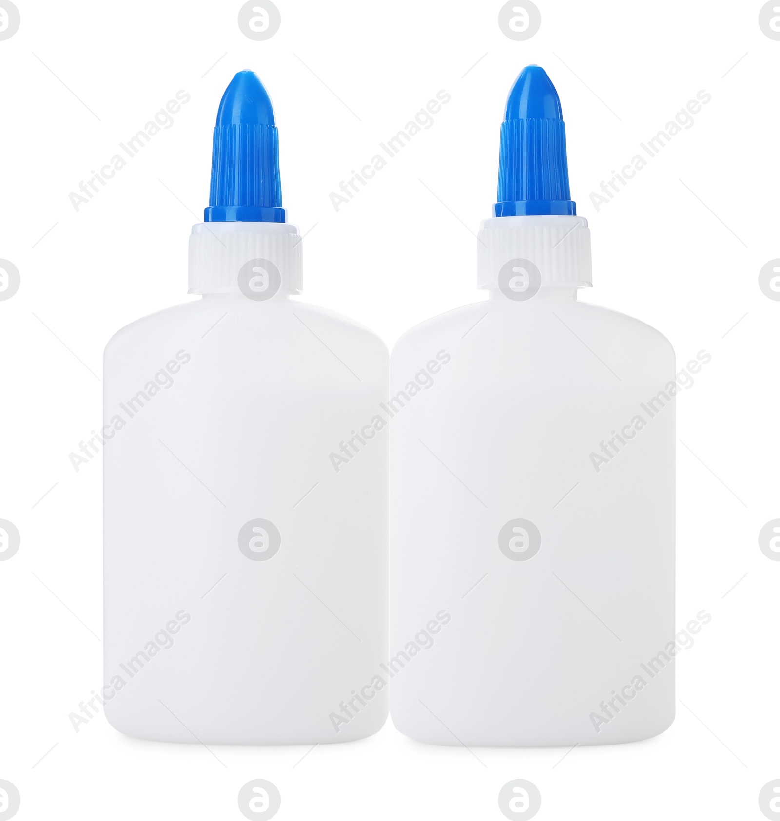 Photo of Bottles of glue with caps isolated on white