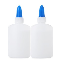 Photo of Bottles of glue with caps isolated on white