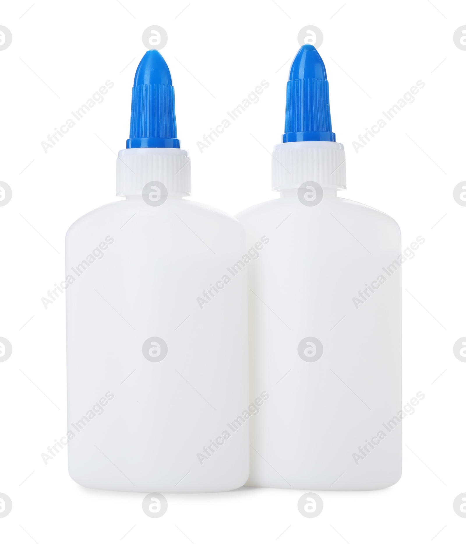 Photo of Bottles of glue with caps isolated on white