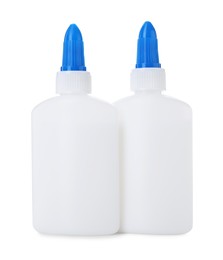 Photo of Bottles of glue with caps isolated on white