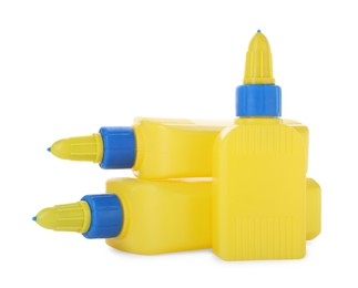 Photo of Bottles of glue with caps isolated on white