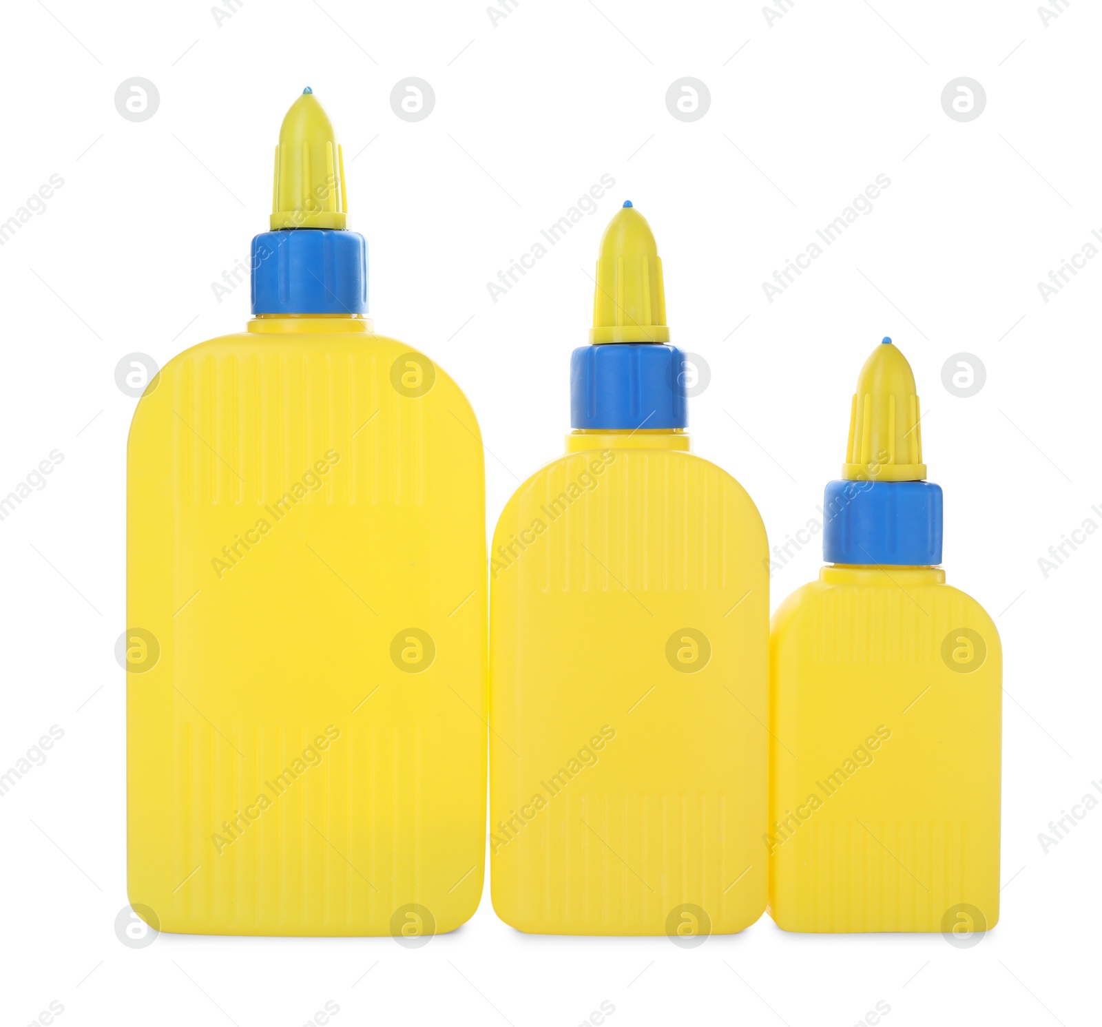 Photo of Bottles of glue with caps isolated on white