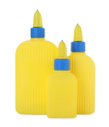 Photo of Bottles of glue with caps isolated on white