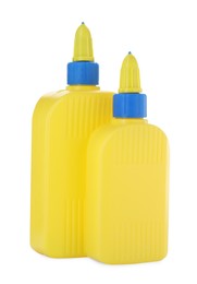 Photo of Bottles of glue with caps isolated on white