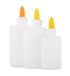 Photo of Bottles of glue with caps isolated on white