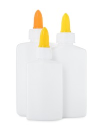 Photo of Bottles of glue with caps isolated on white