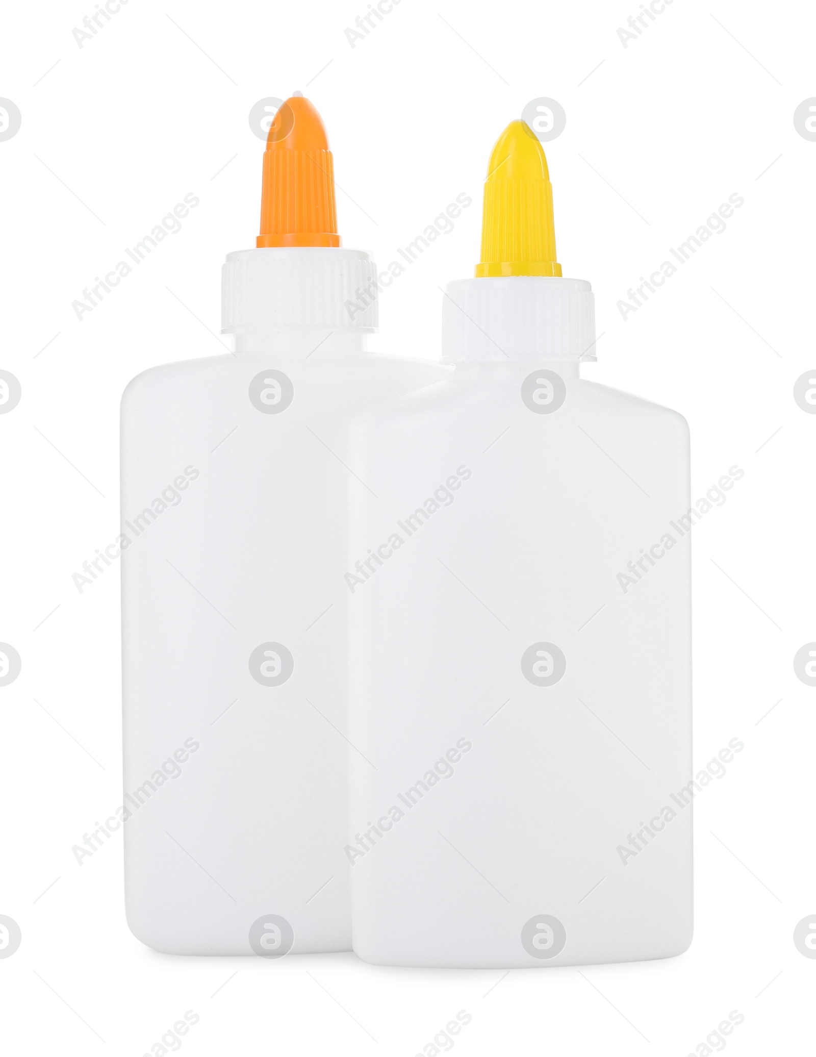 Photo of Bottles of glue with caps isolated on white