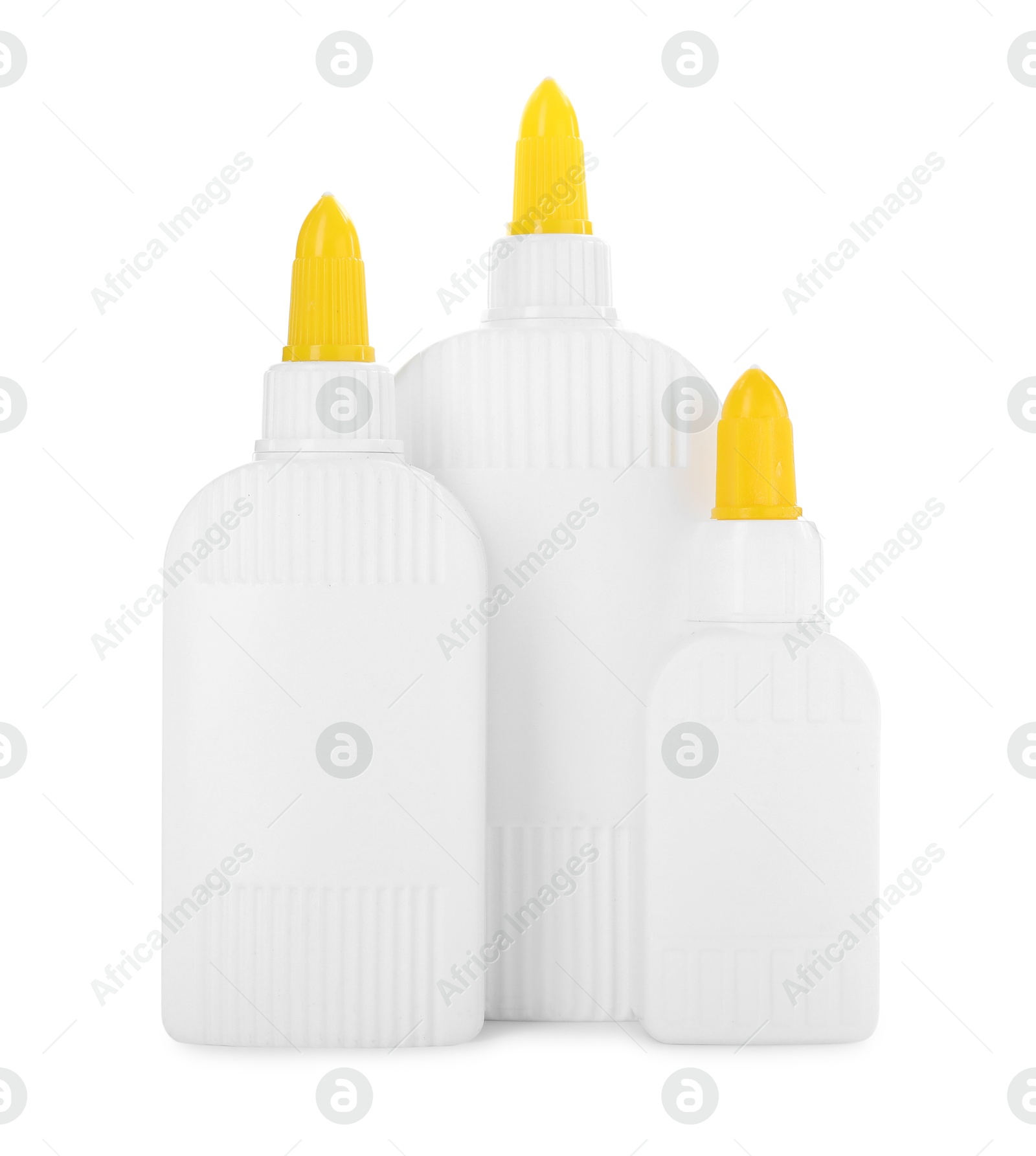 Photo of Bottles of glue with caps isolated on white