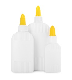 Photo of Bottles of glue with caps isolated on white