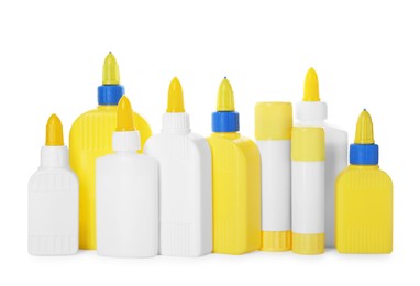 Photo of Bottles and sticks of glue on white background