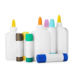 Photo of Bottles and sticks of glue on white background