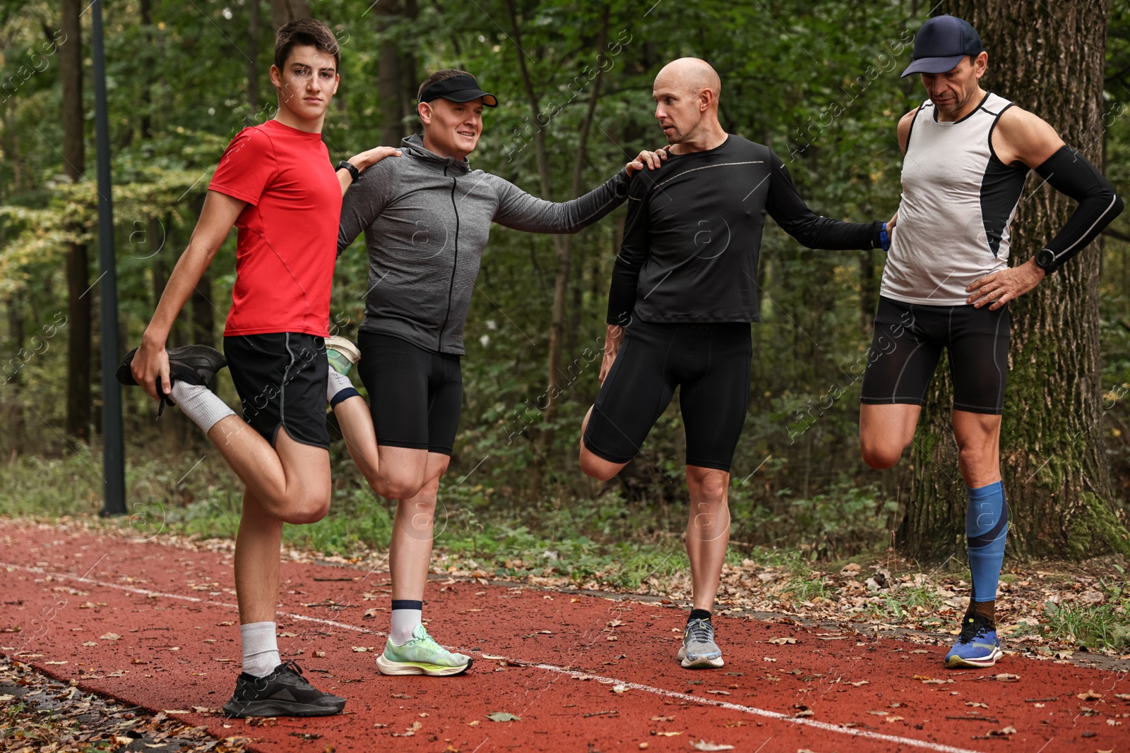 Photo of Group of people stretching in park. Healthy lifestyle