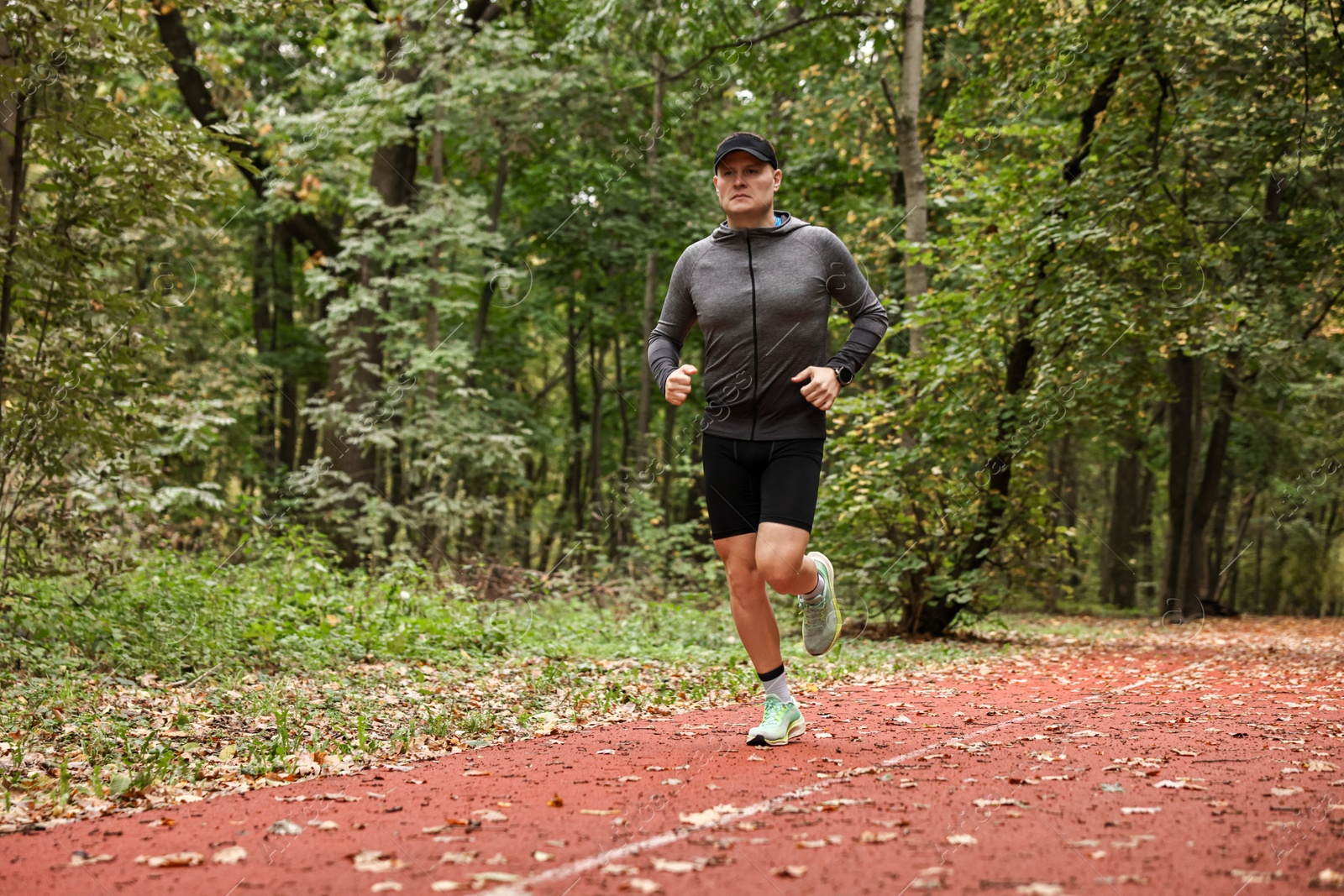 Photo of Athletic man running in park. Healthy lifestyle