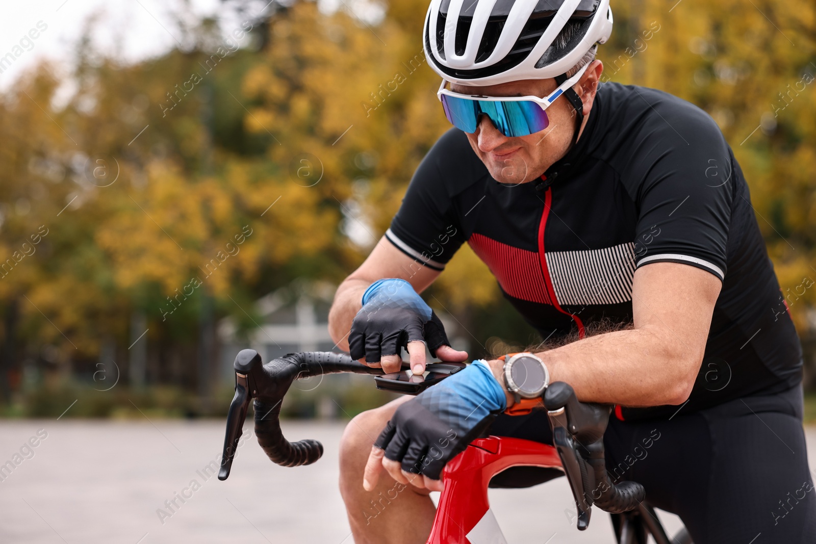 Photo of Athletic man with helmet and bicycle outdoors