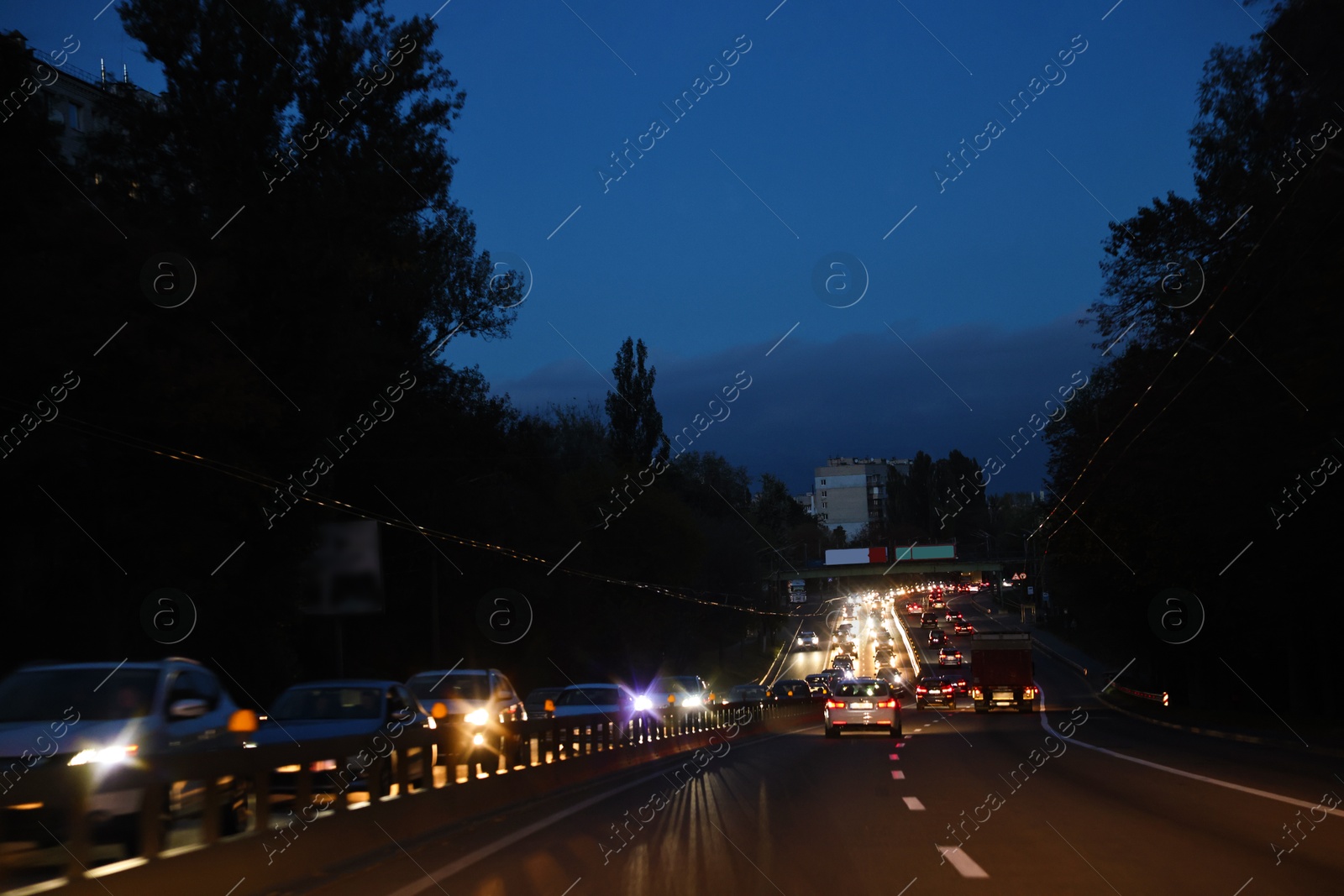 Photo of Cityscape with road traffic and street lights in evening