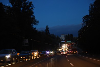 Photo of Cityscape with road traffic and street lights in evening