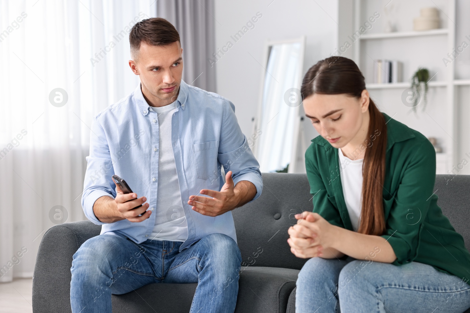 Photo of Upset woman ignoring her husband at home