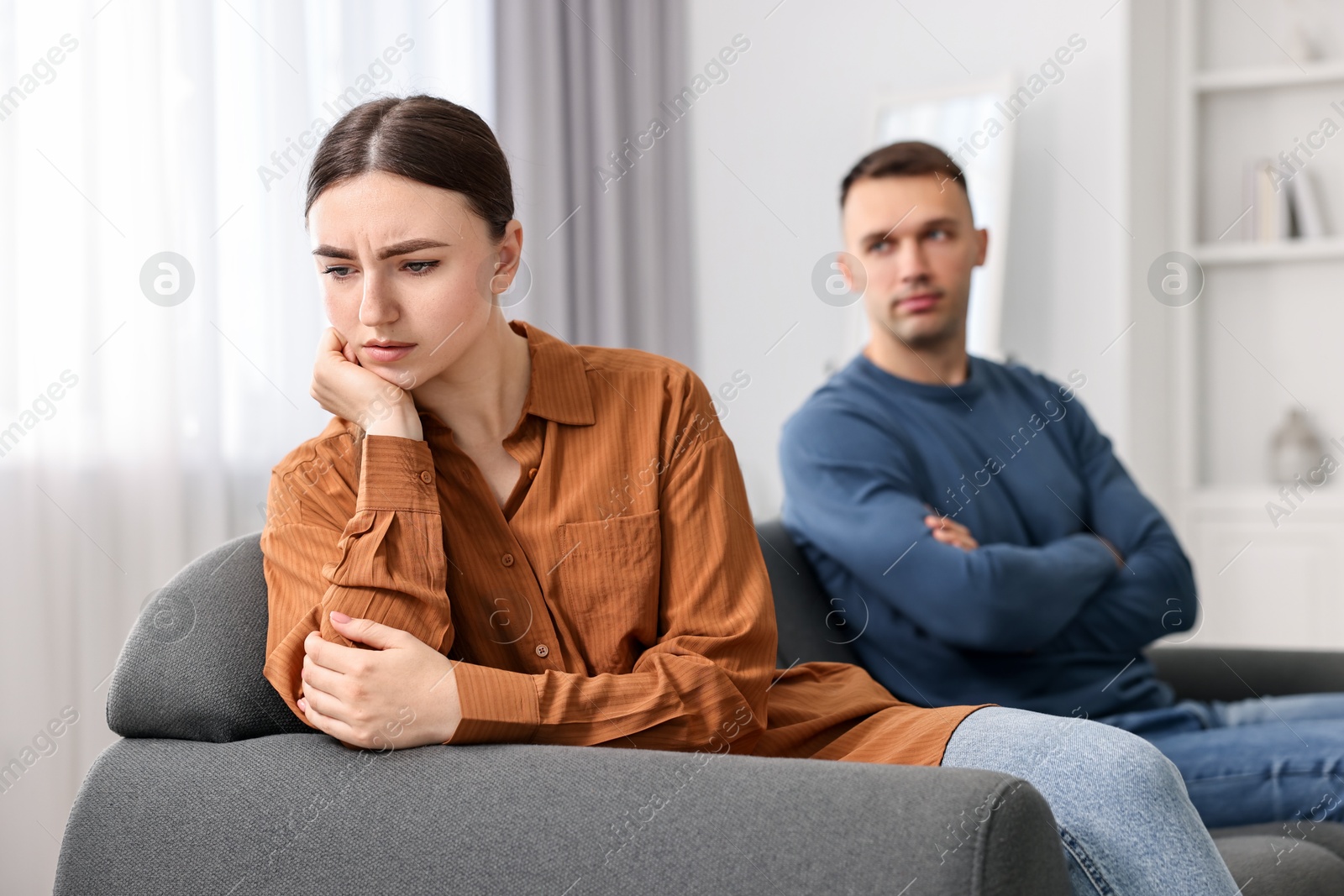 Photo of Upset couple after quarrel at home, selective focus