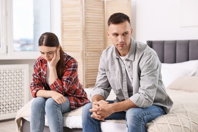 Offended couple ignoring each other at home