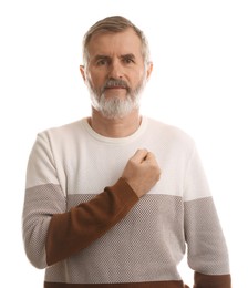 Mature man making promise on white background. Oath gesture