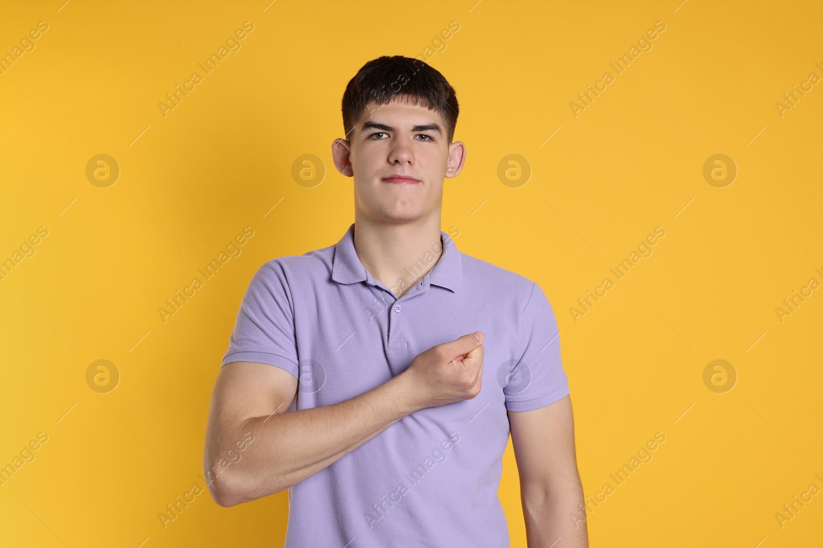 Photo of Man showing oath gesture on orange background