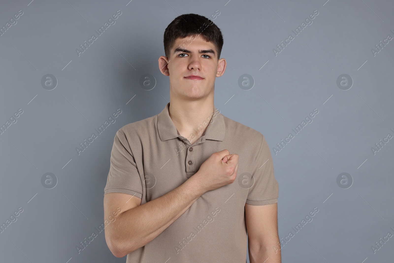 Photo of Man showing oath gesture on grey background