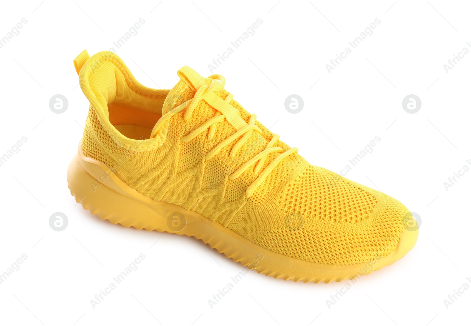 Photo of One stylish yellow sneaker isolated on white