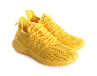 Photo of Pair of stylish yellow sneakers isolated on white