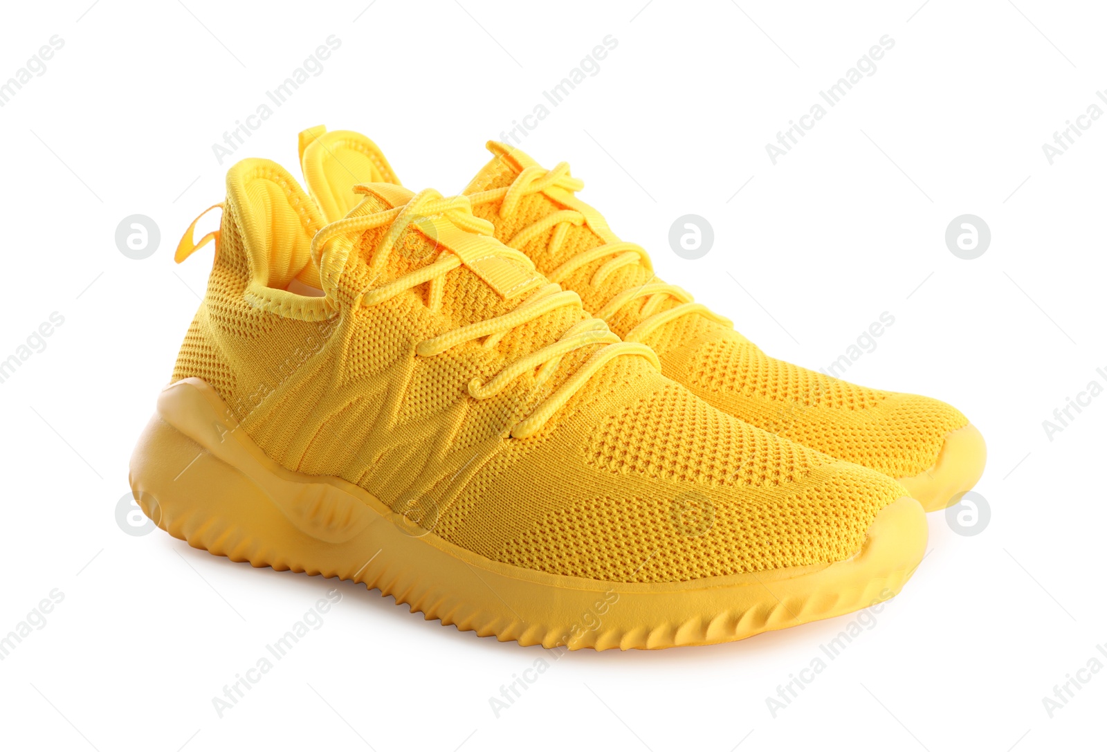 Photo of Pair of stylish yellow sneakers isolated on white