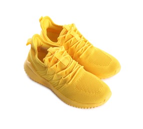 Photo of Pair of stylish yellow sneakers isolated on white