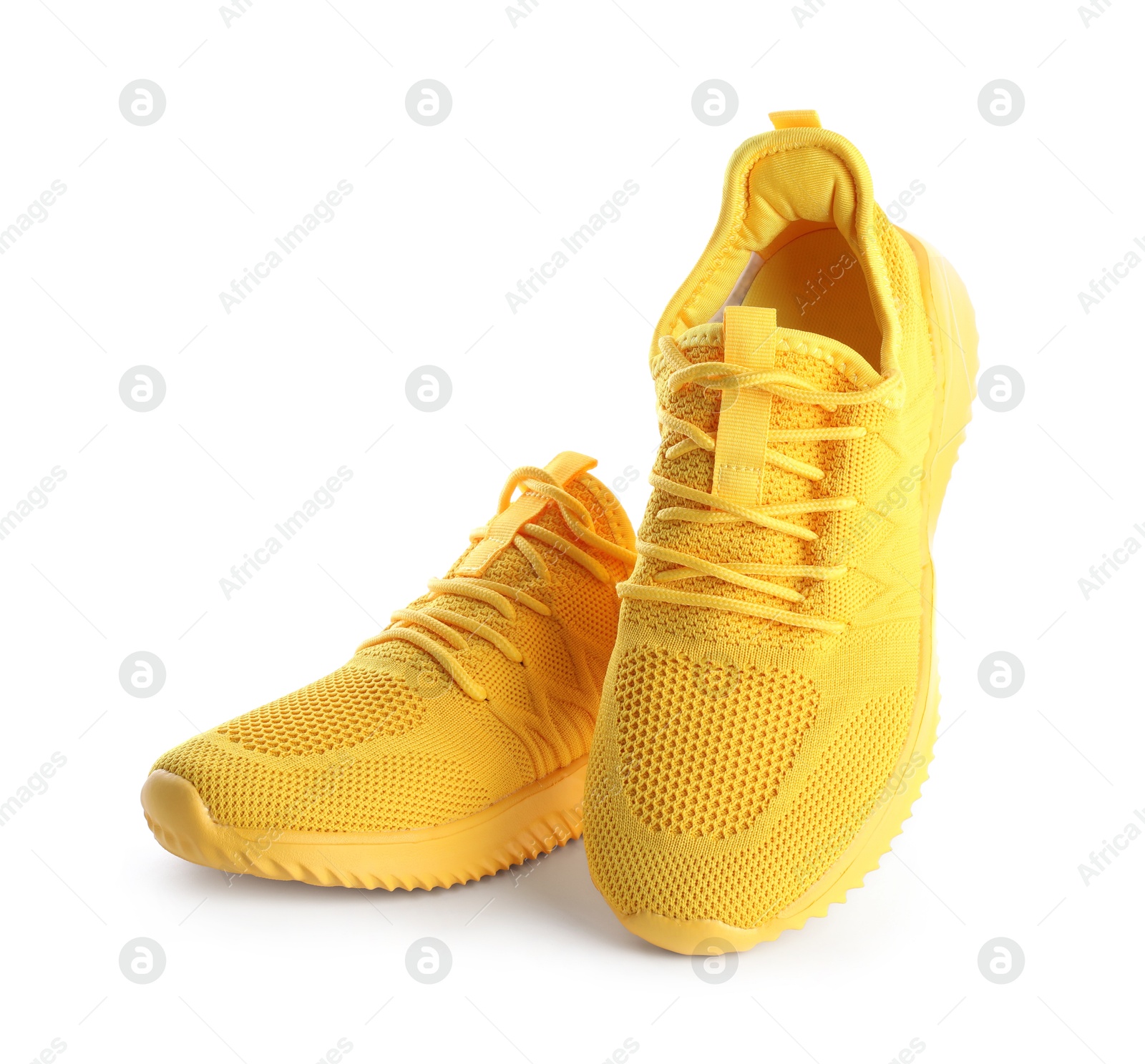 Photo of Pair of stylish yellow sneakers isolated on white