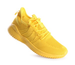 Photo of One stylish yellow sneaker isolated on white