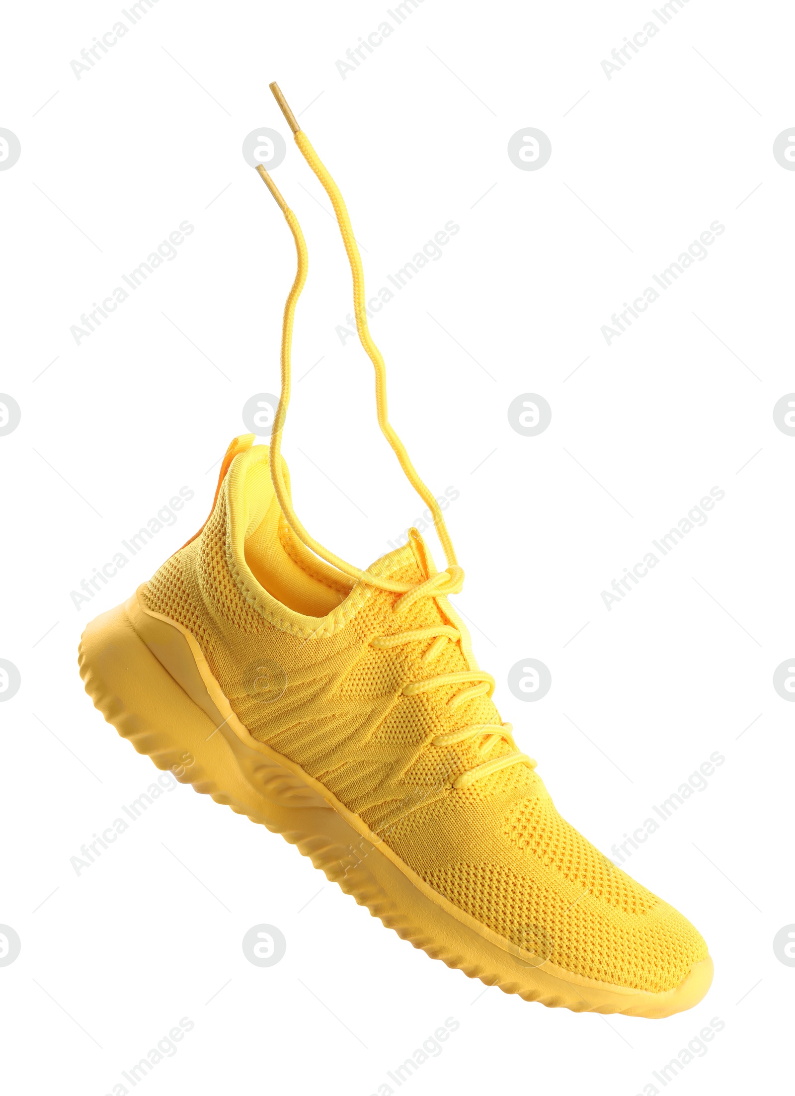 Photo of One stylish yellow sneaker isolated on white