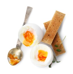 Photo of Soft boiled eggs, bread and spoon isolated on white, top view