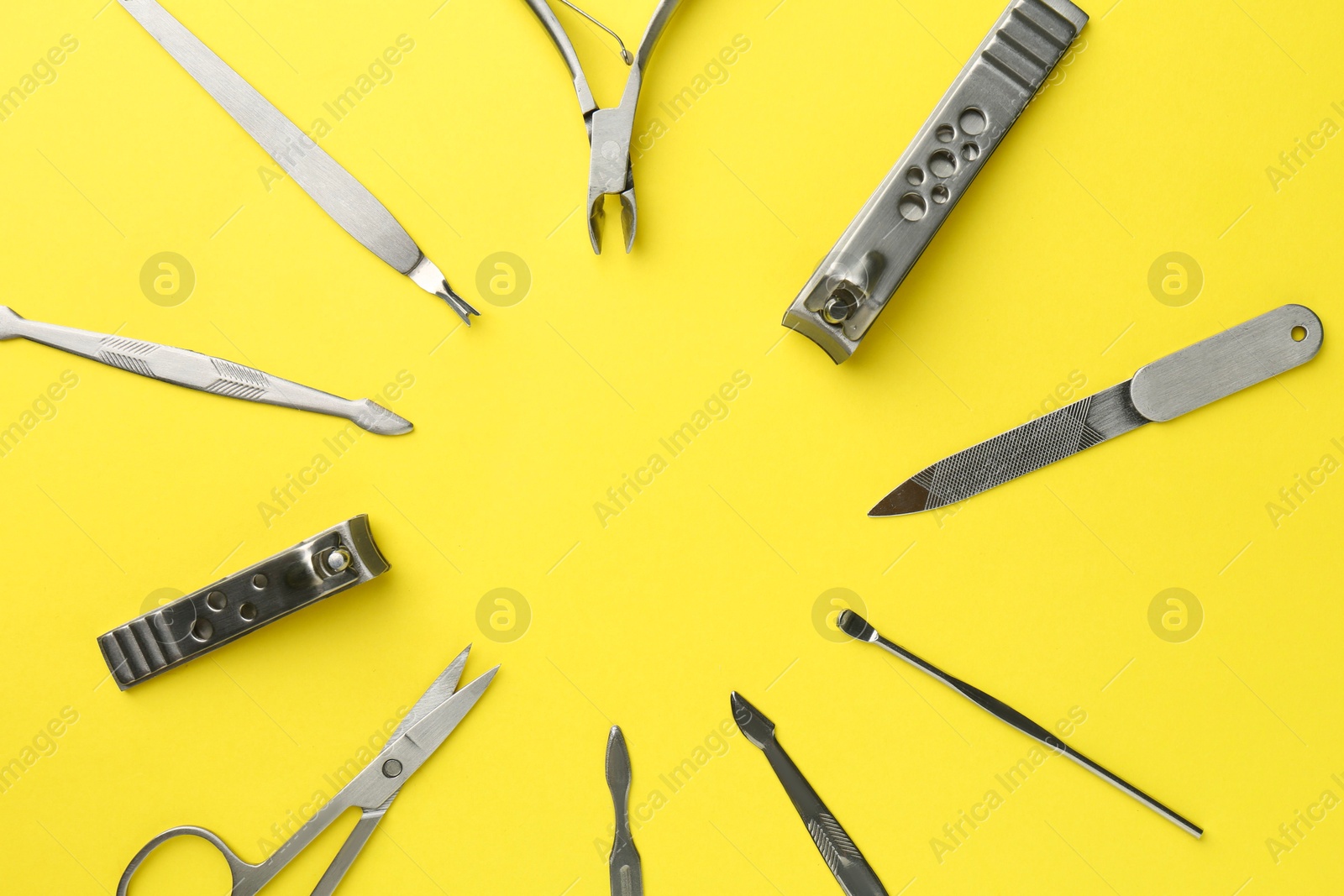 Photo of Frame of pedicure tools on yellow background, flat lay. Space for text