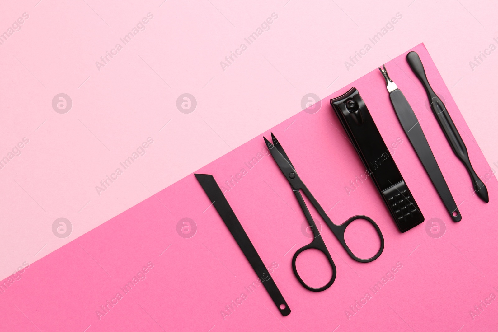 Photo of Set of pedicure tools on color background, flat lay. Space for text