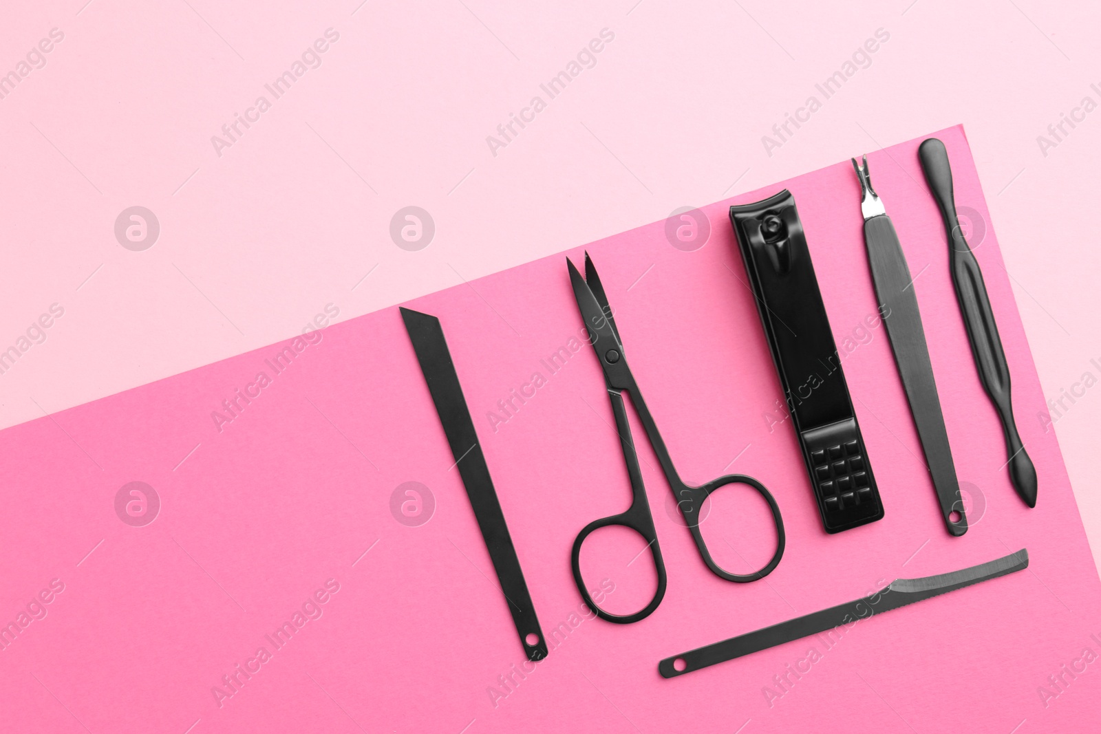 Photo of Set of pedicure tools on color background, flat lay. Space for text