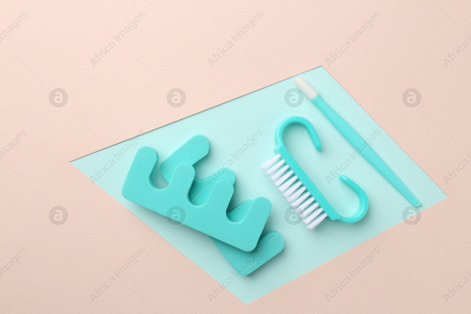 Photo of Set of pedicure tools on color background, flat lay