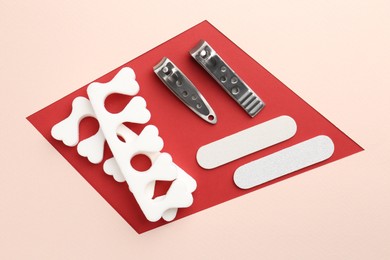 Photo of Set of pedicure tools on color background, flat lay