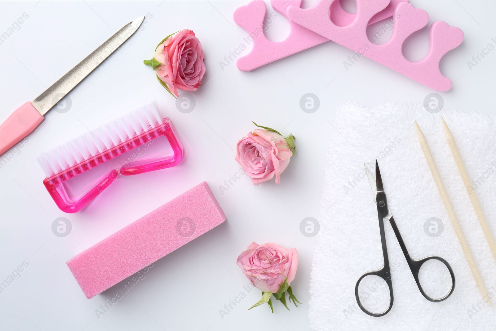 Photo of Set of pedicure tools on light background, flat lay