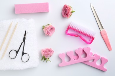 Photo of Set of pedicure tools on light background, flat lay