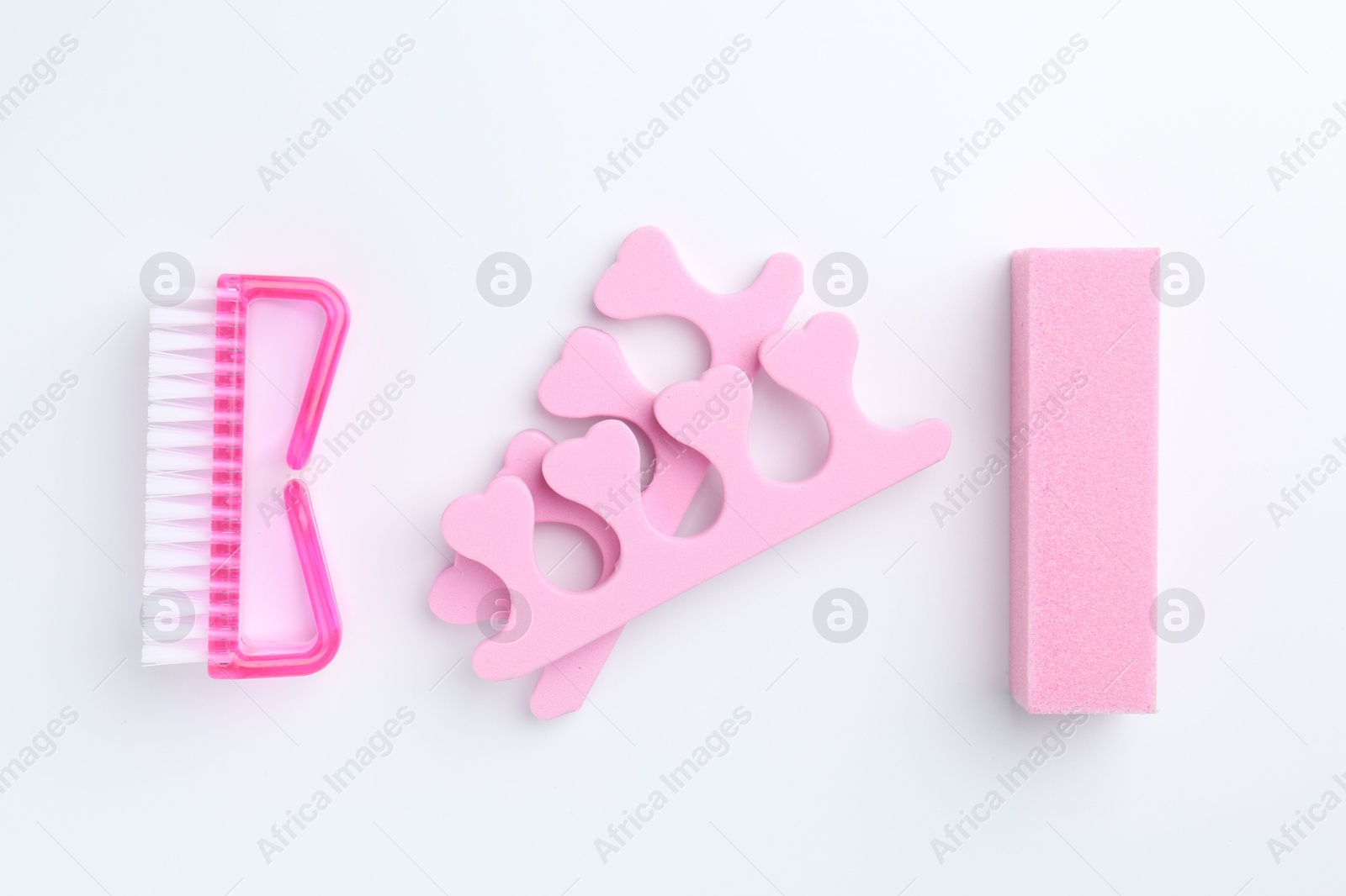 Photo of Set of pedicure tools on light background, flat lay