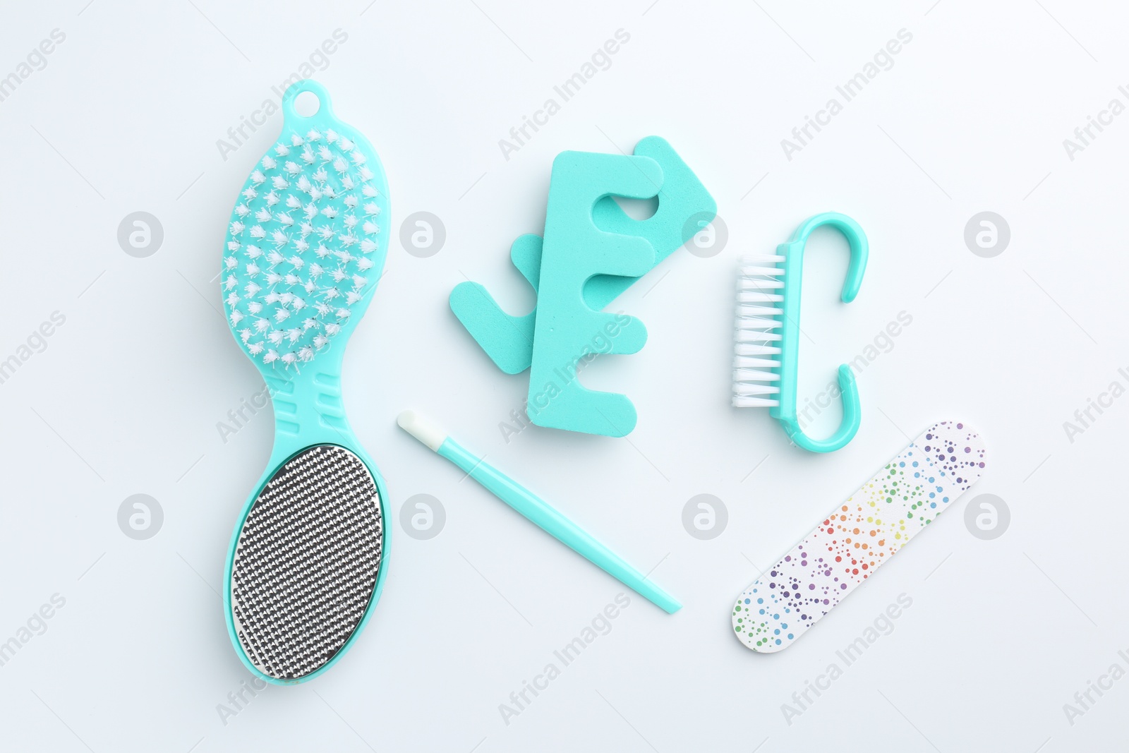 Photo of Set of pedicure tools on light background, flat lay