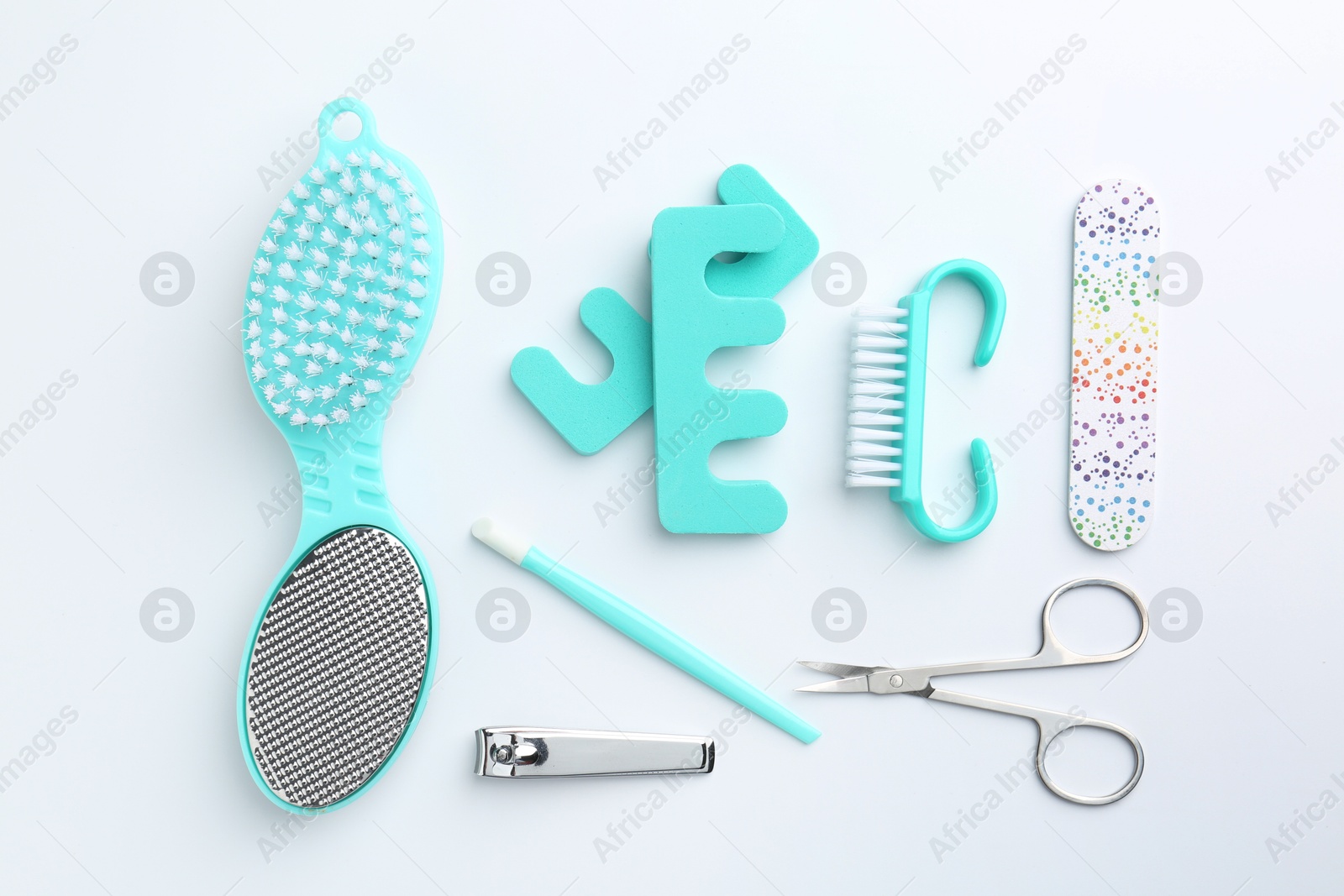 Photo of Set of pedicure tools on light background, flat lay