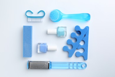 Photo of Set of pedicure tools on light background, flat lay