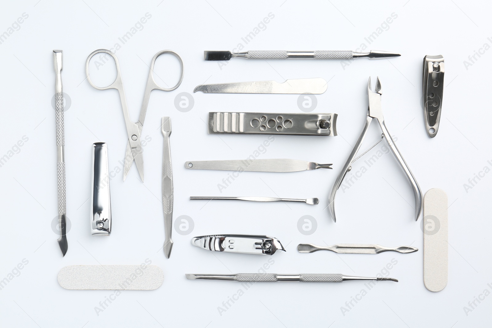 Photo of Set of pedicure tools on light background, flat lay