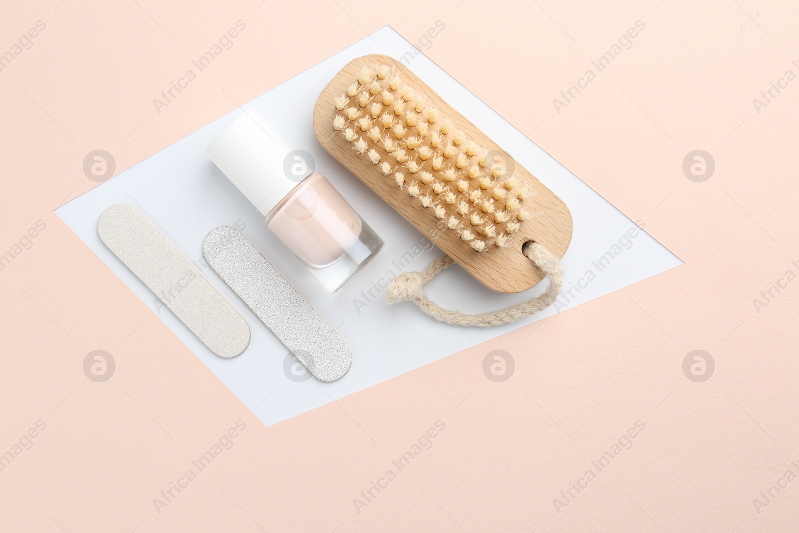 Photo of Pedicure procedure. Nail polish, files and brush on color background, flat lay